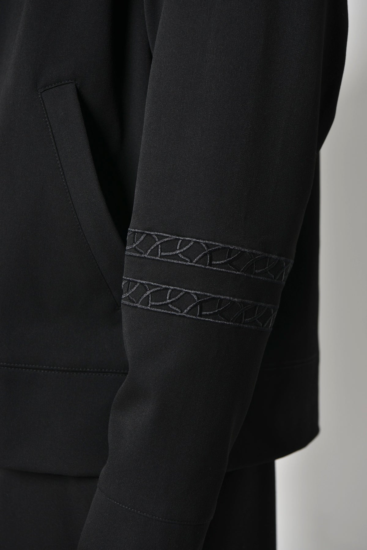 Sleeve of the Tailored Collared Jacket with two bands of tonal Chain embroidery near the cuff